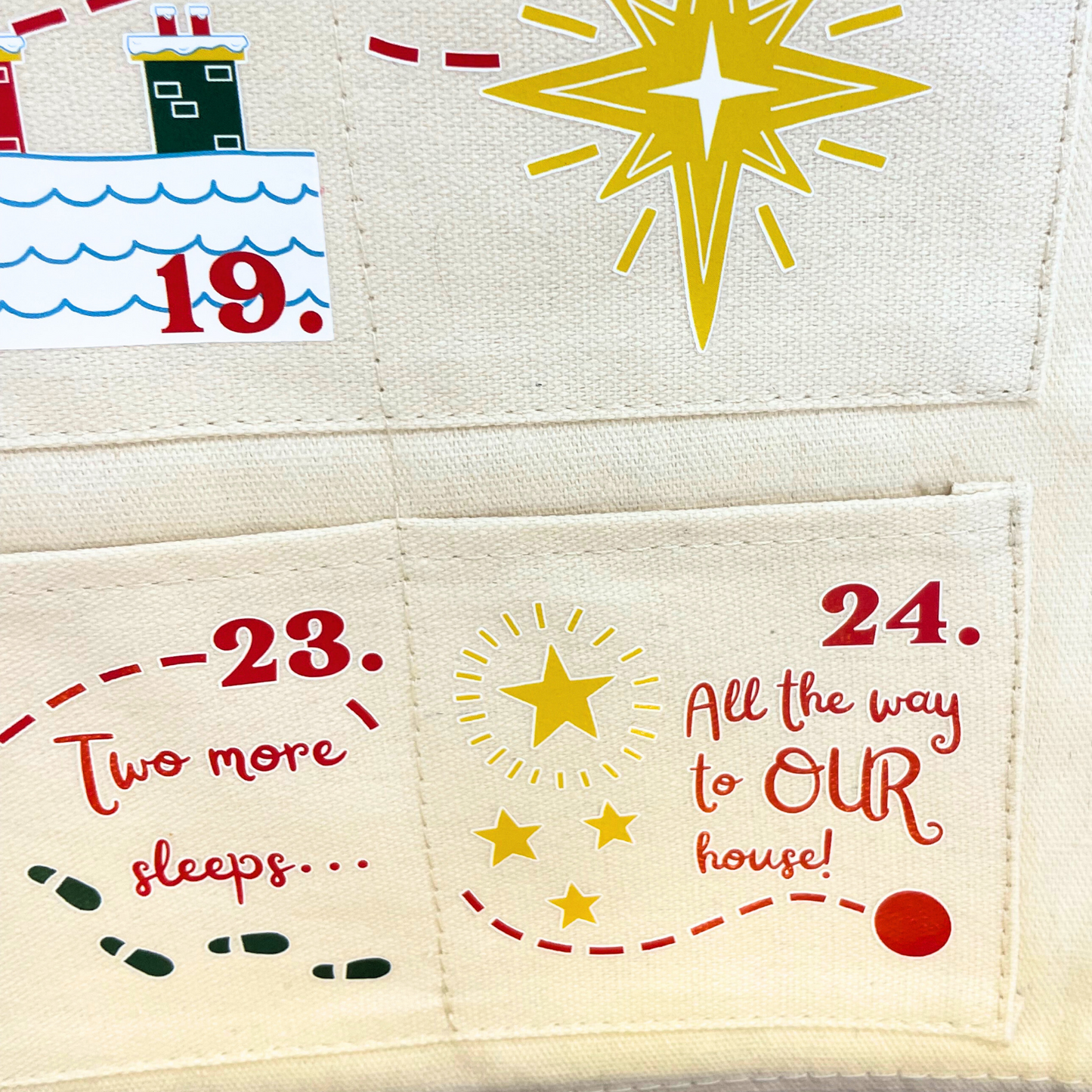 A festive close-up of the personalised advent calendar with a filled pocket, showing the "Santa's journey" countdown detail.