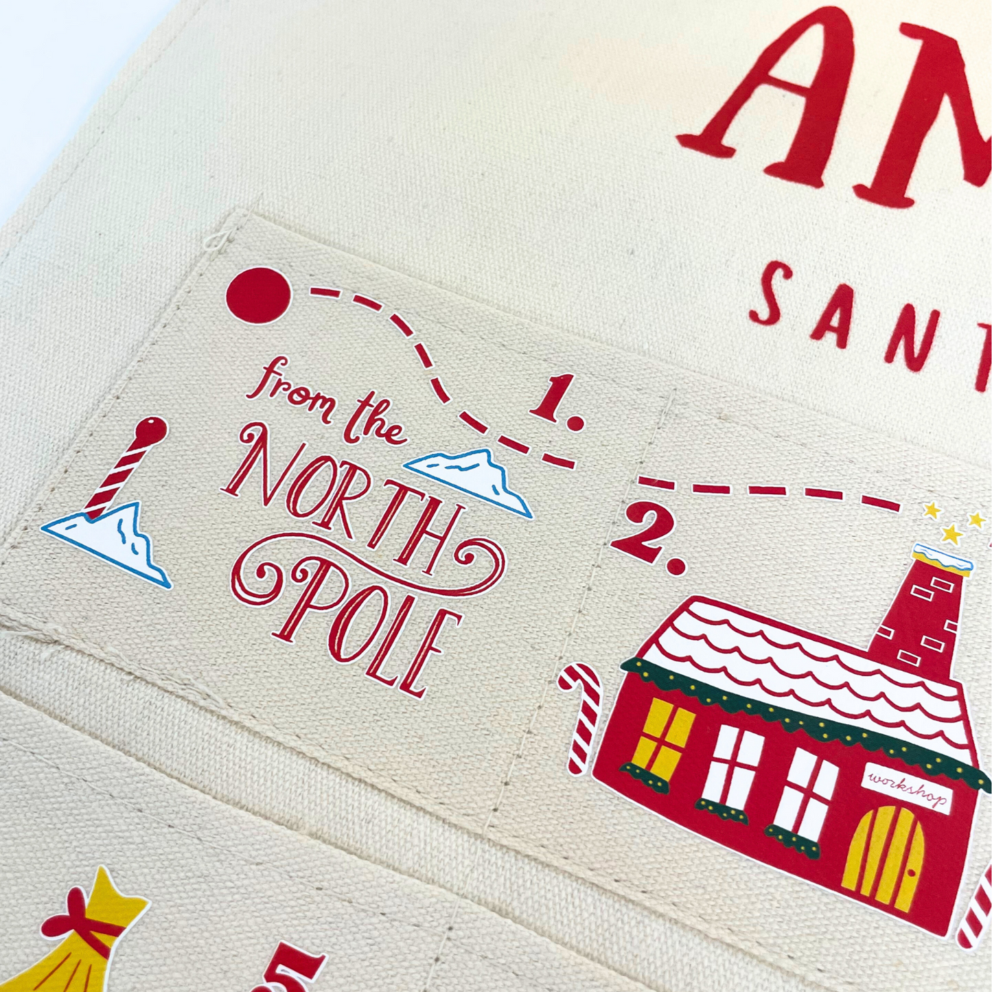 Lifestyle shot of the personalised fabric advent calendar in a festive Christmas living room setting.